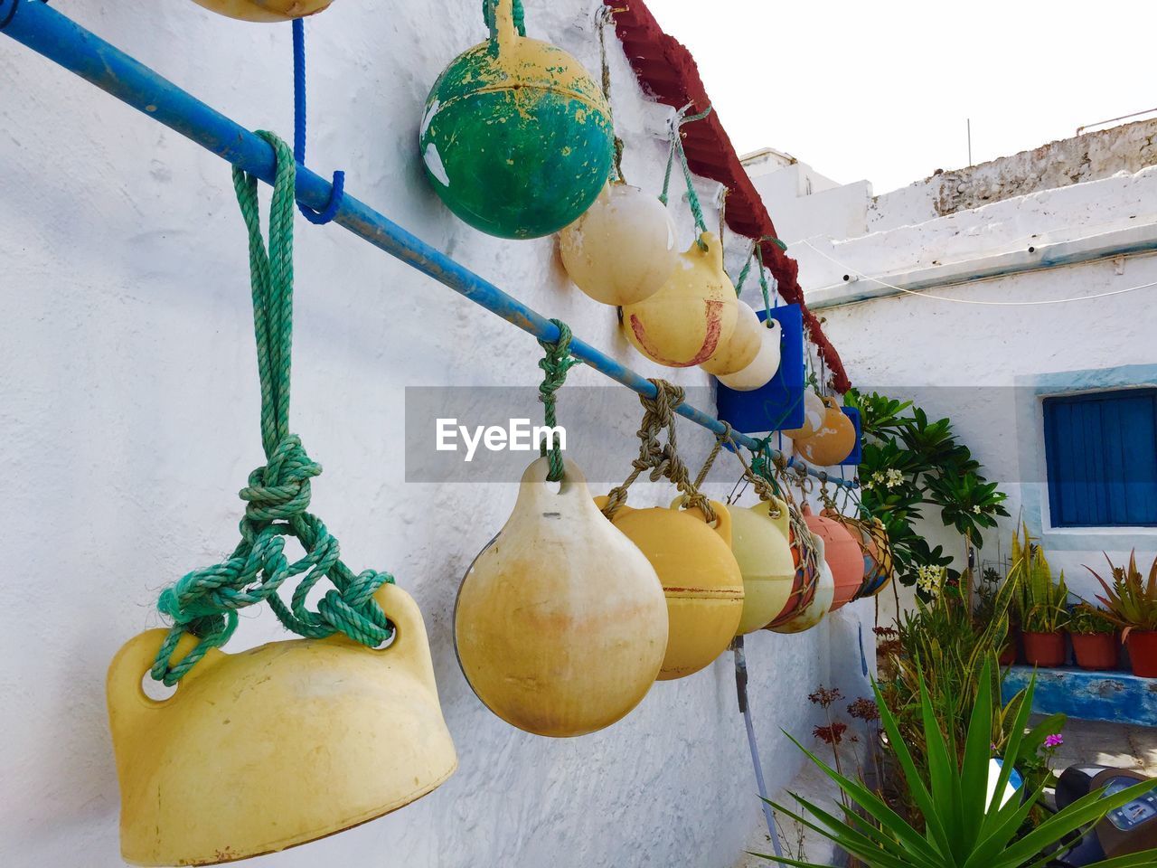 Buoys hanging from rod outside house