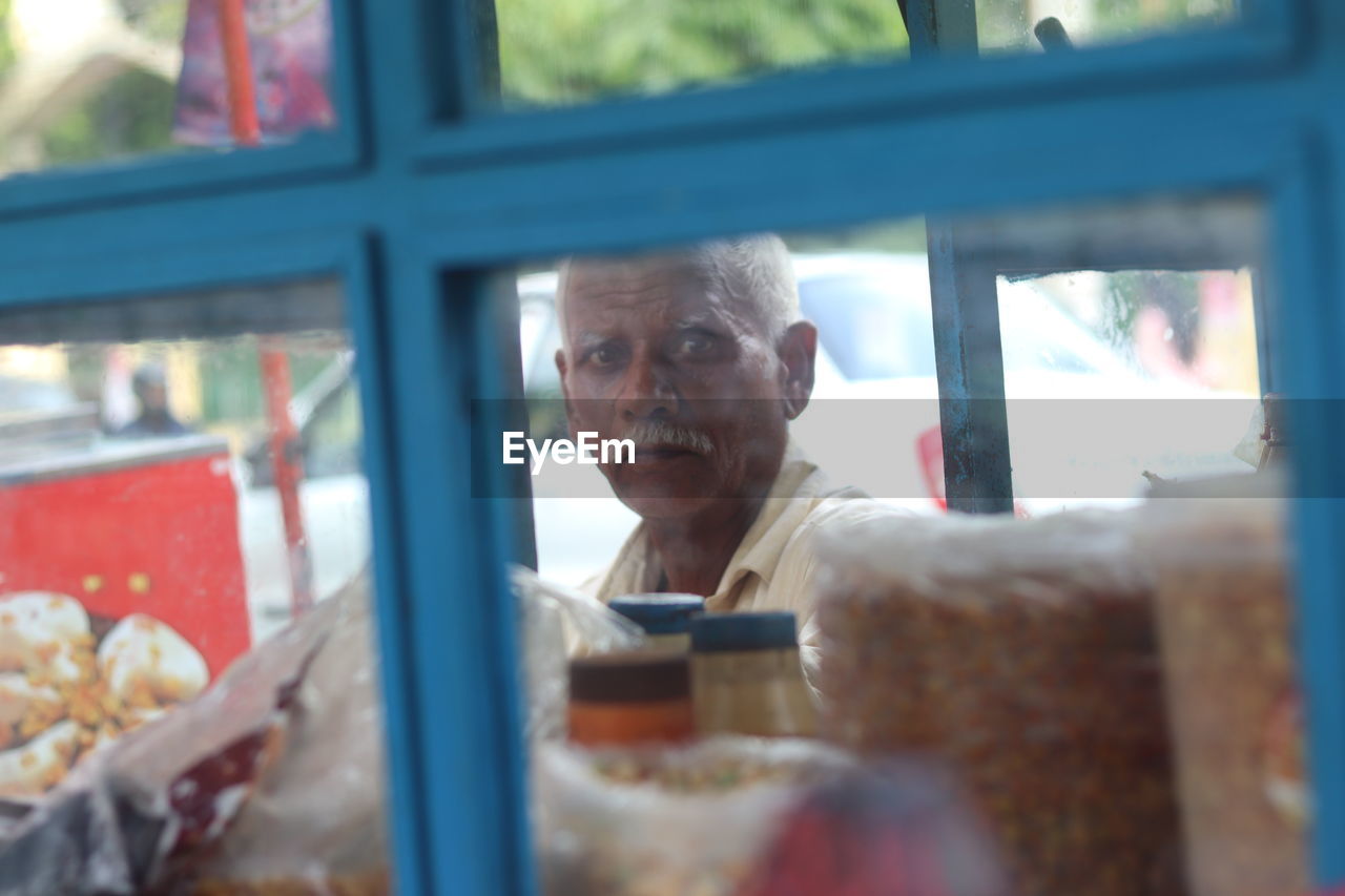 PORTRAIT OF A YOUNG MAN LOOKING AT WINDOW