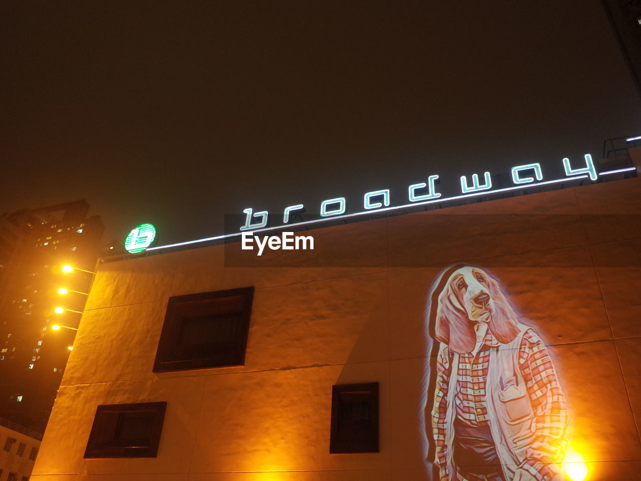 LOW ANGLE VIEW OF ILLUMINATED TEXT AT NIGHT