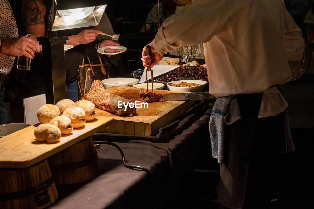 Midsection of man preparing food on table