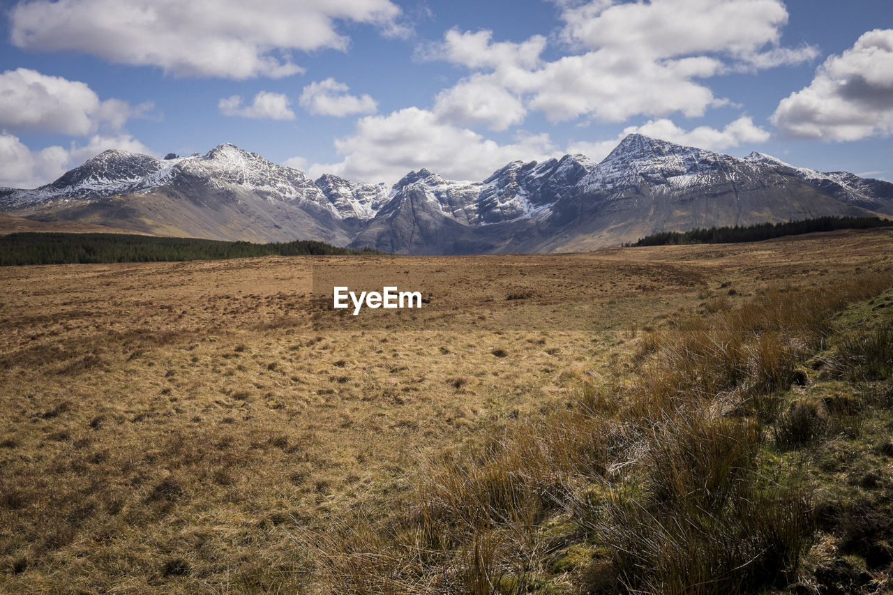 Scenic view of mountains against cloudy sky