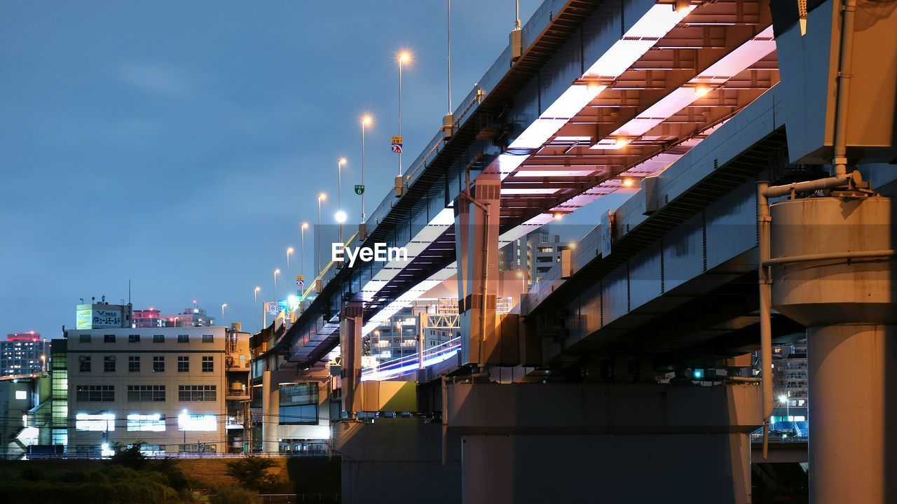 Low angle view of illuminated buildings against sky in city