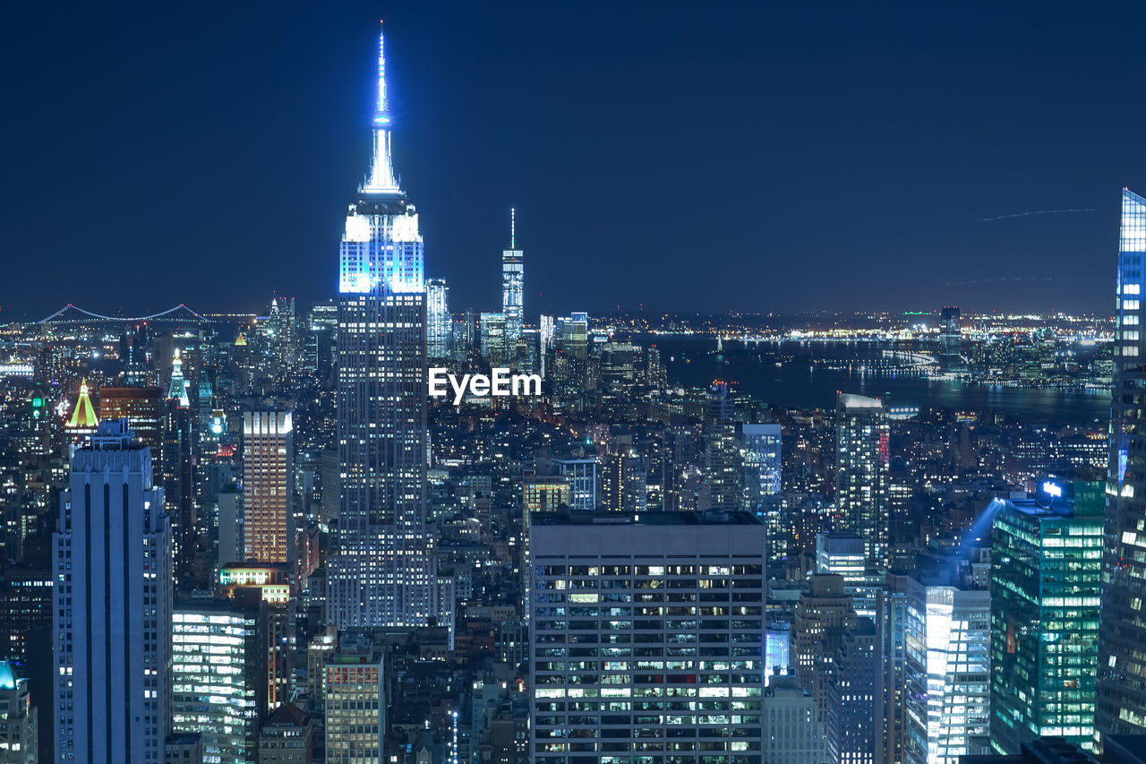 high angle view of illuminated buildings in city at night