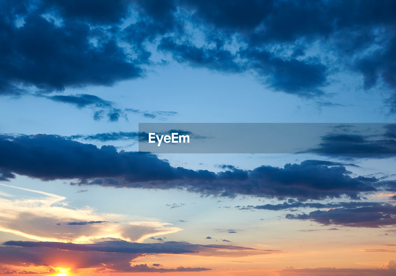 LOW ANGLE VIEW OF DRAMATIC SKY OVER SILHOUETTE LANDSCAPE