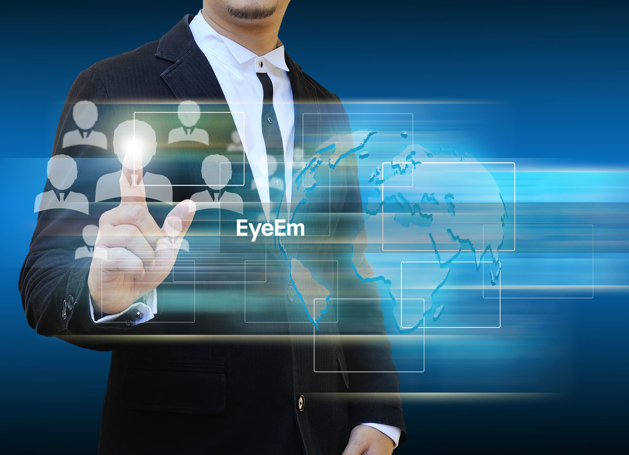 Digital composite image of businessman with symbols against blue background
