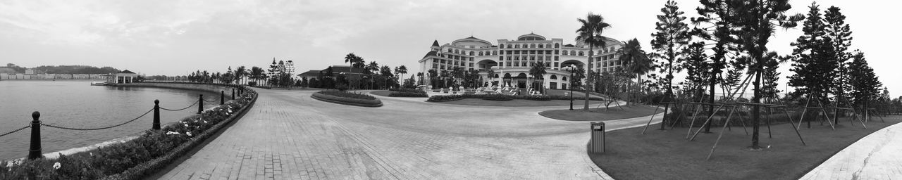 Panoramic view of buildings against cloudy sky