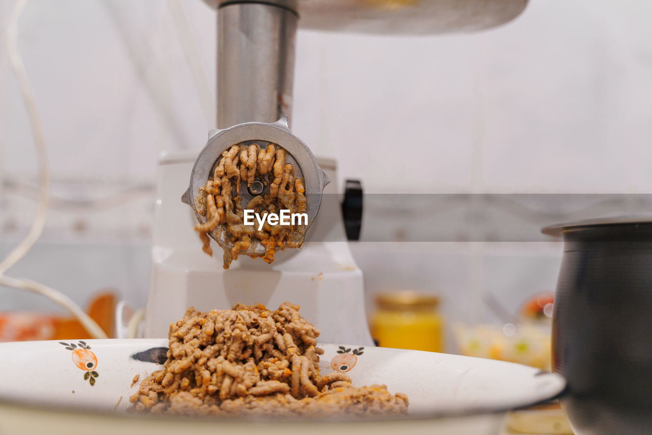 Meat grinder at home kitchen. lifestyle photography. food preparing