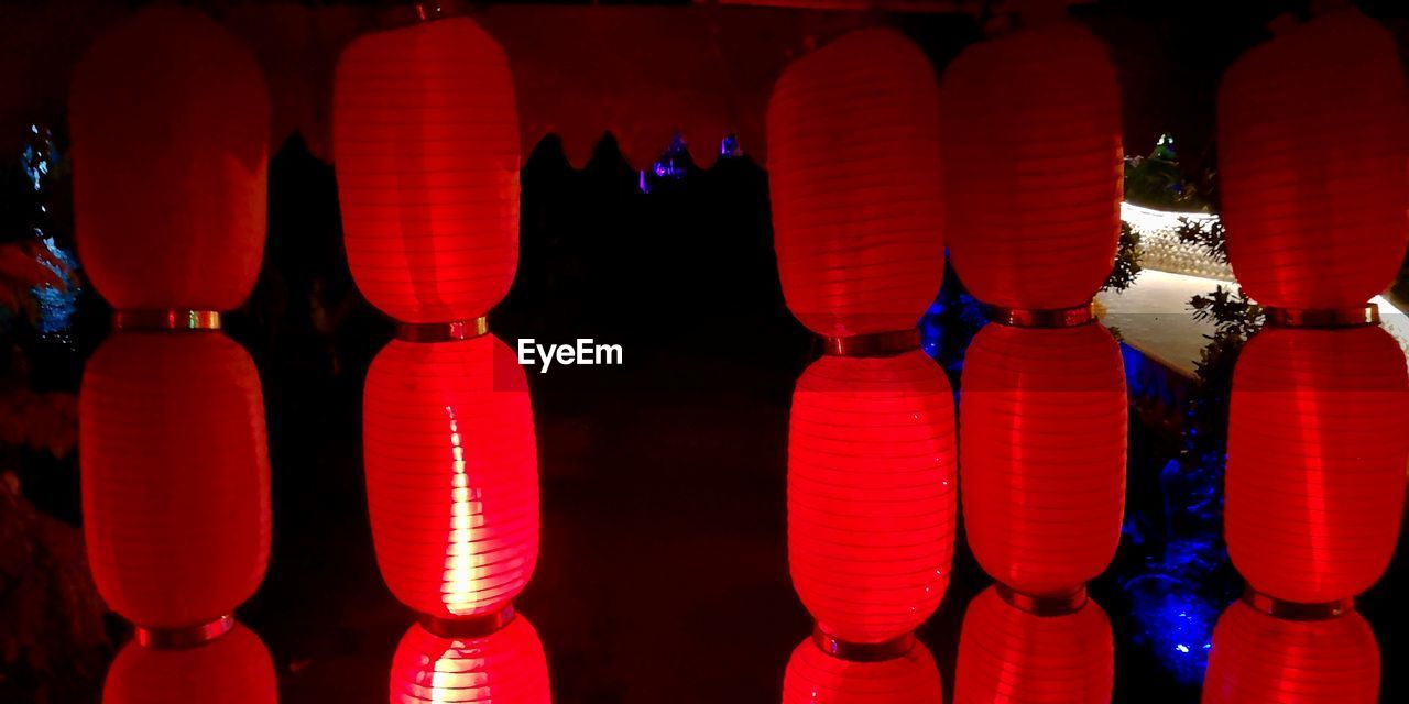 RED LANTERNS HANGING IN ROW AT MARKET