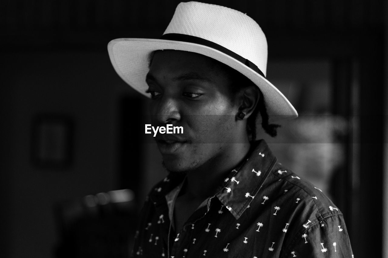 Close-up of mid adult man looking away at night