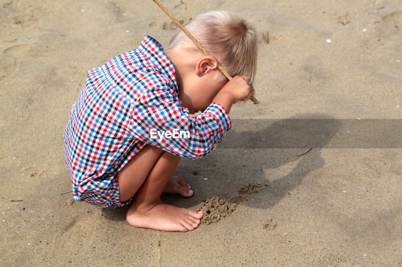 High angle view of boy playing on beach