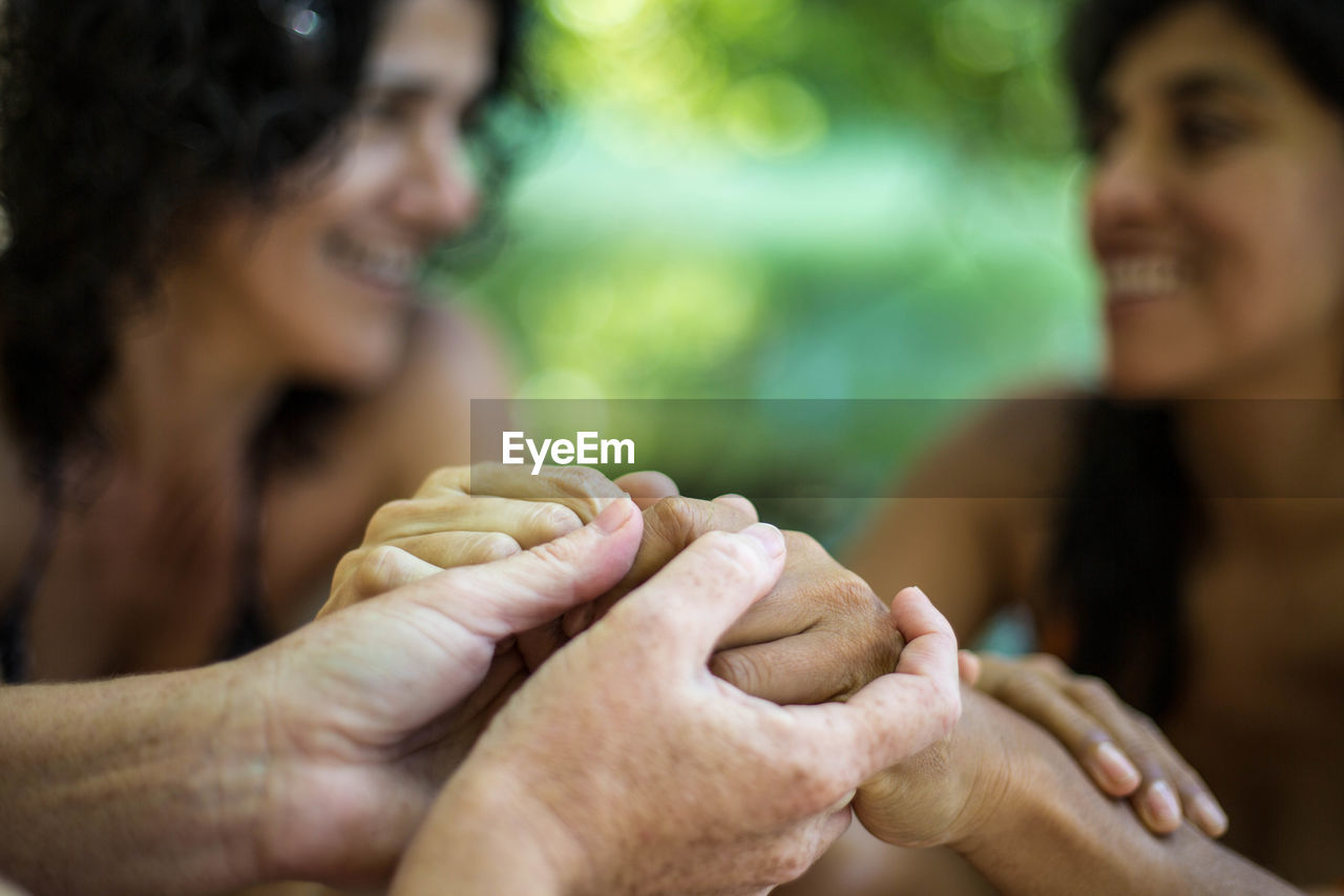 Close-up of people holding hands