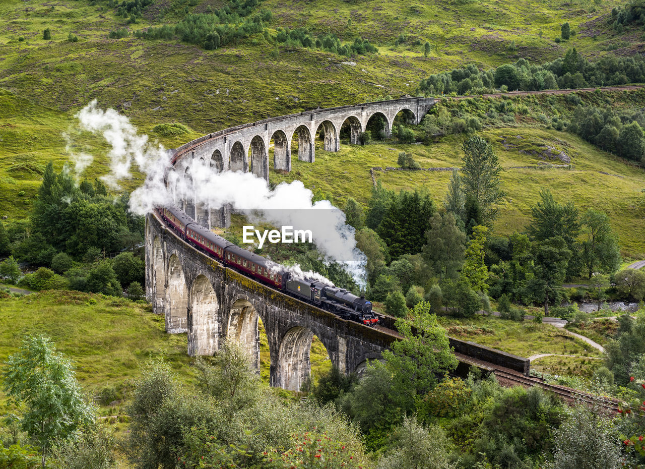 High angle view of train on bridge amidst landscape