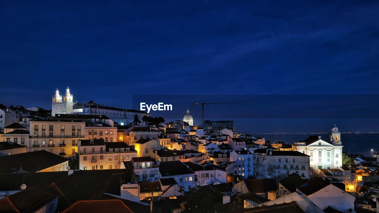 Illuminated city skyline in a shiby night in lisbon, portugal architecture 