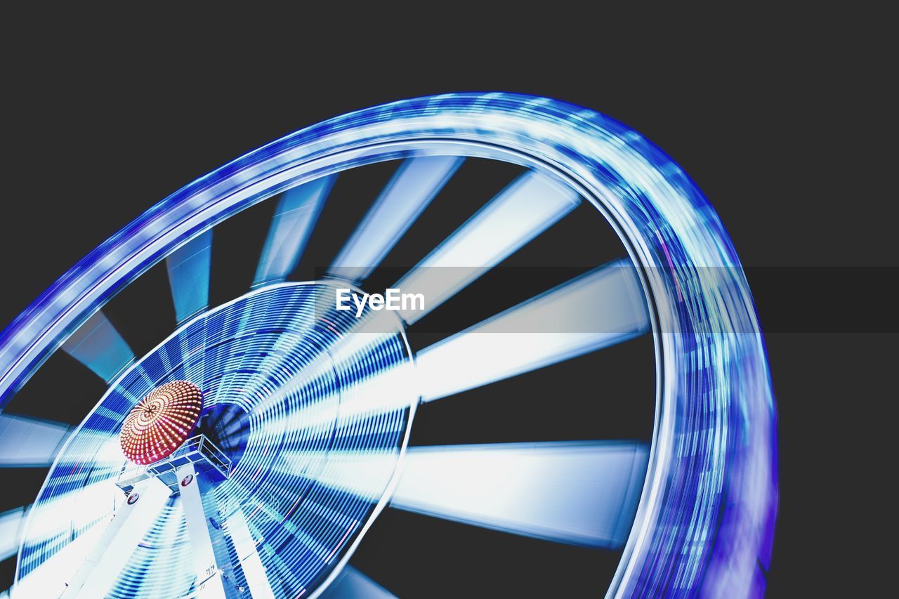 Low angle view of illuminated ferris wheel at night