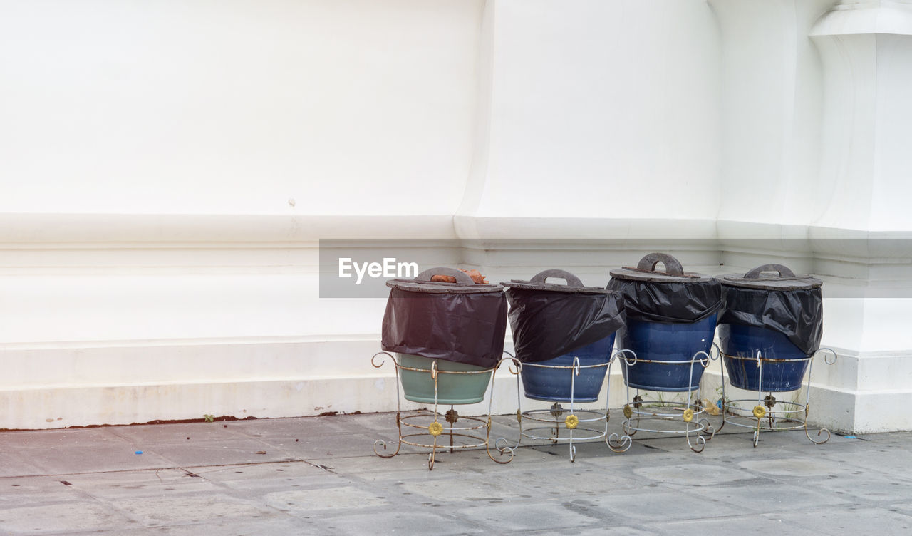 Bin and broom and white wall., cleaning concept., with copy space for text.