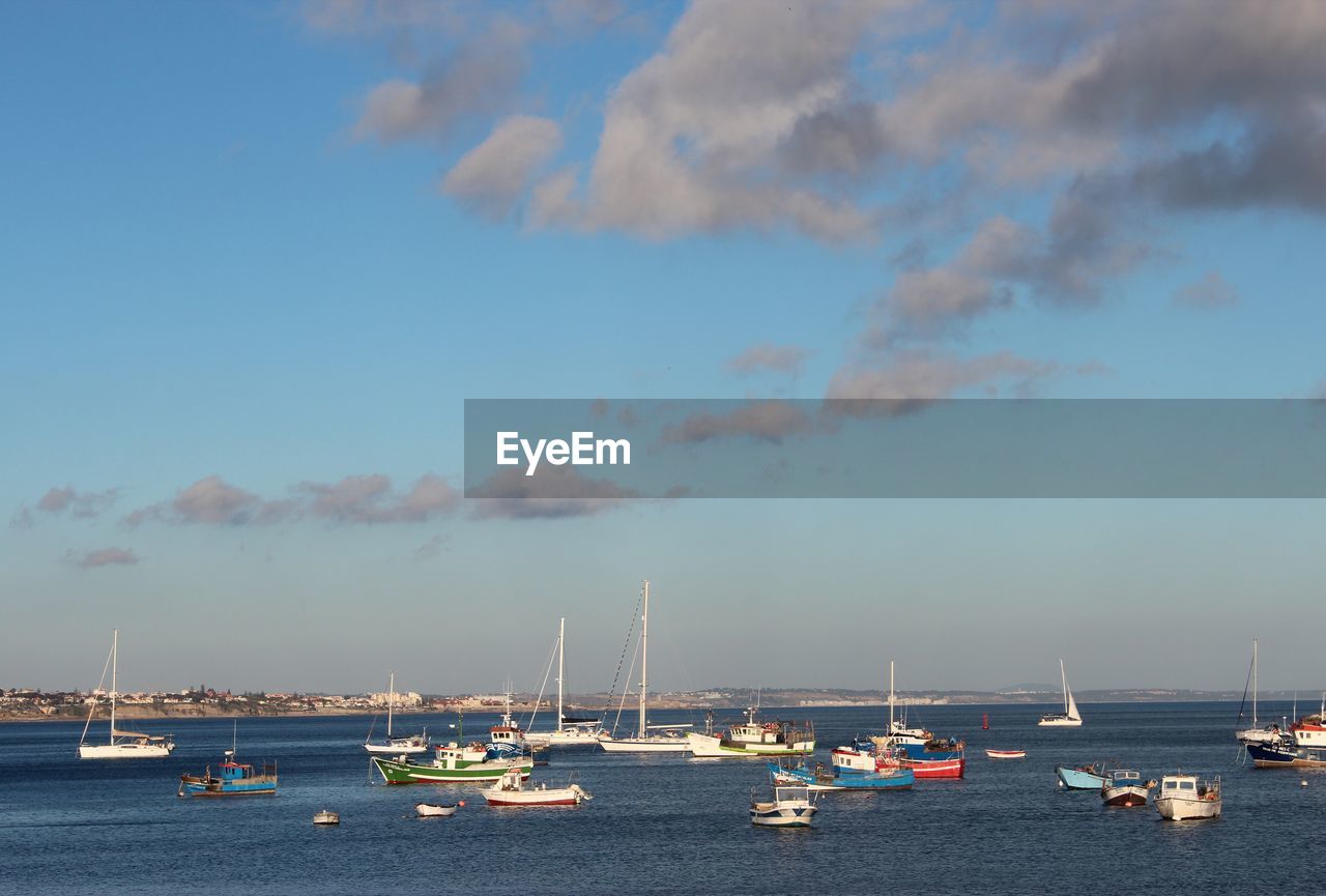 High angle view of boats moored in harbor against sky during sunset