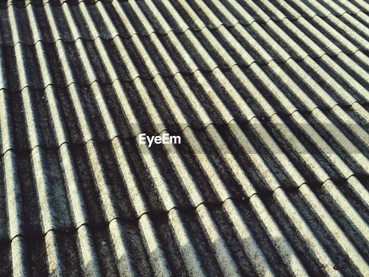 HIGH ANGLE VIEW OF SHADOW ON METAL WALL