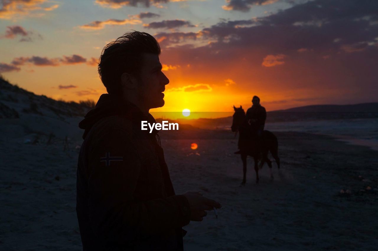 SILHOUETTE OF WOMAN AT SUNSET