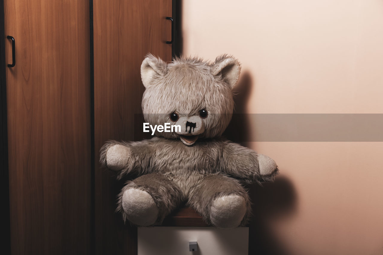 Vintage teddy bear stuffed toy alone in room