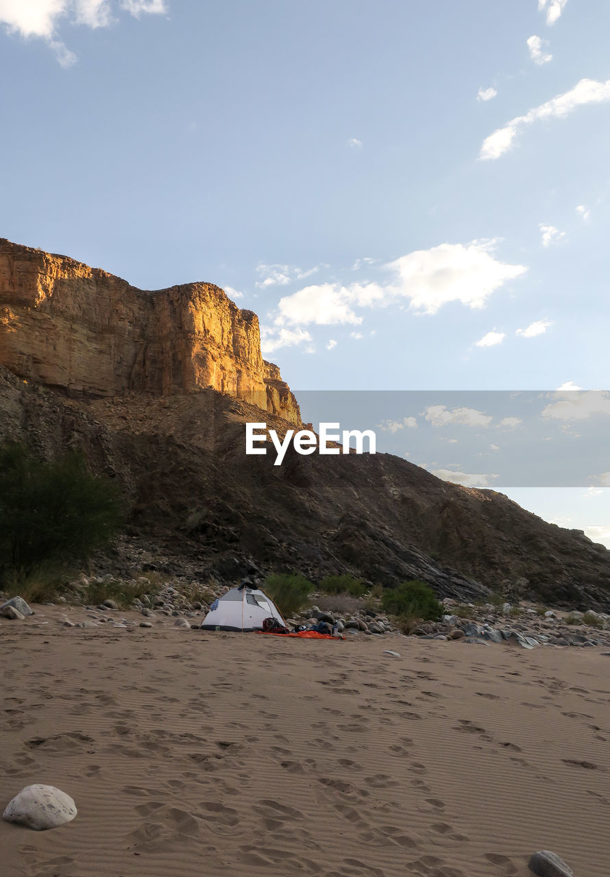 View of desert against cloudy sky