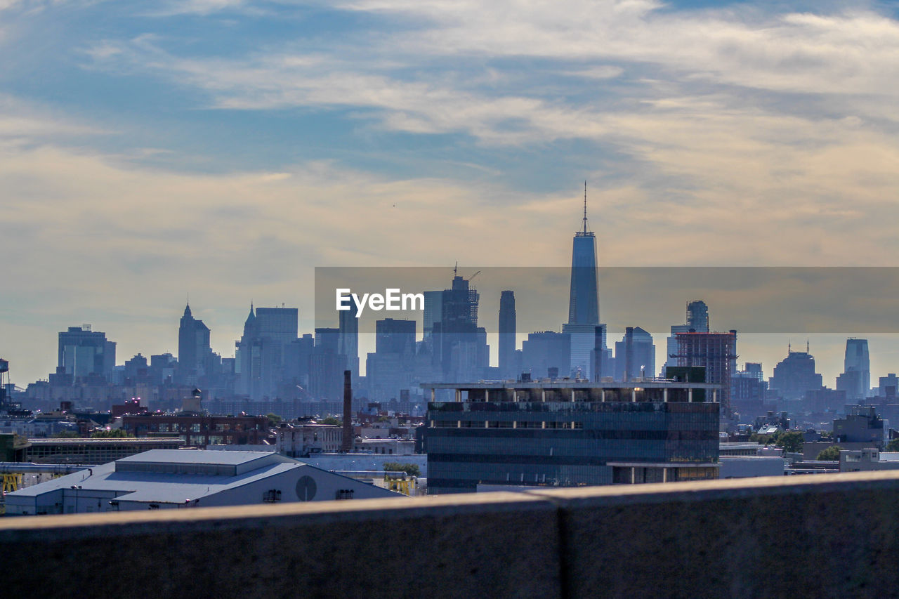 New york skyline, modern buildings in city against cloudy sky
