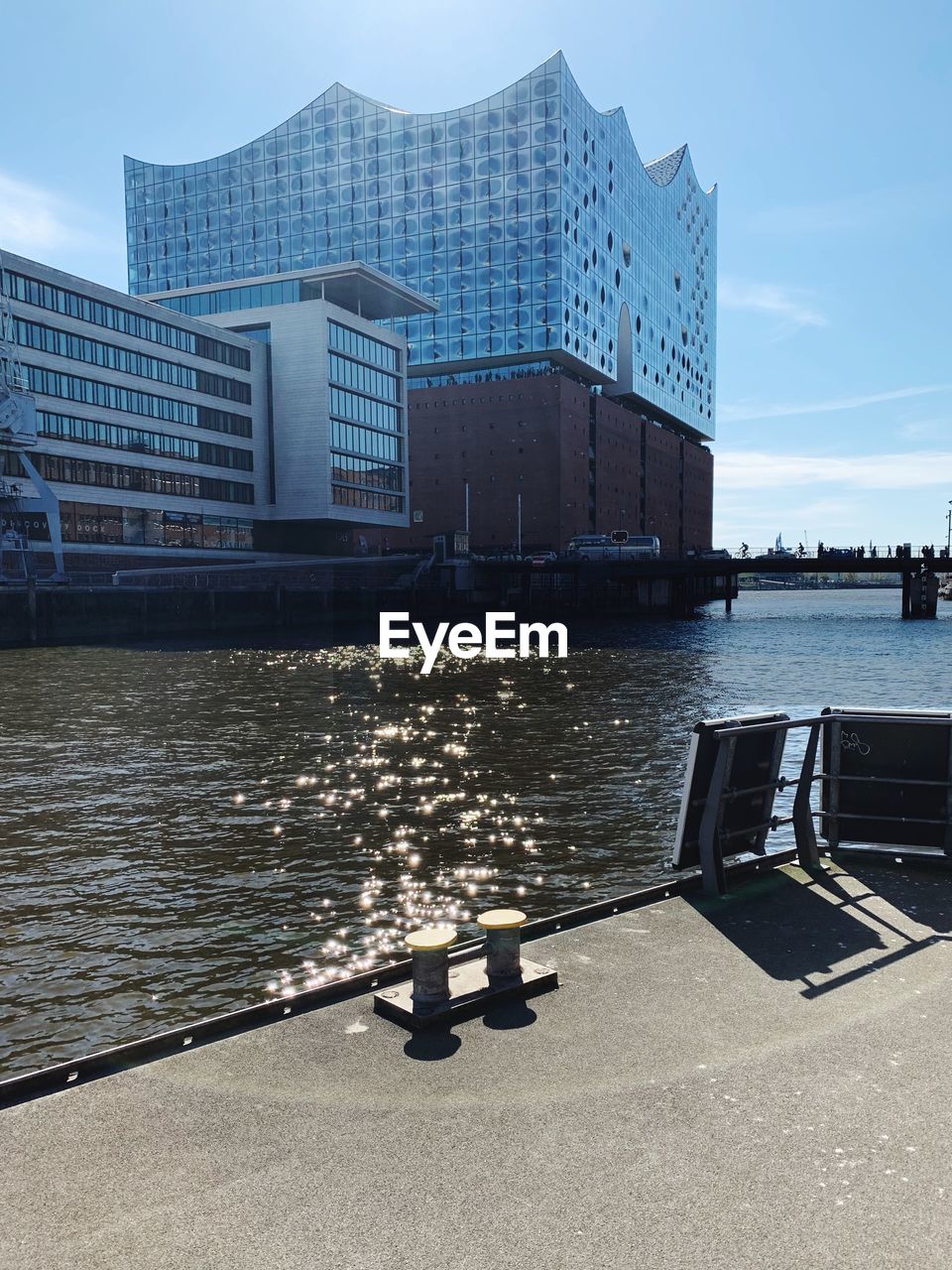 BUILDING BY RIVER IN CITY AGAINST SKY