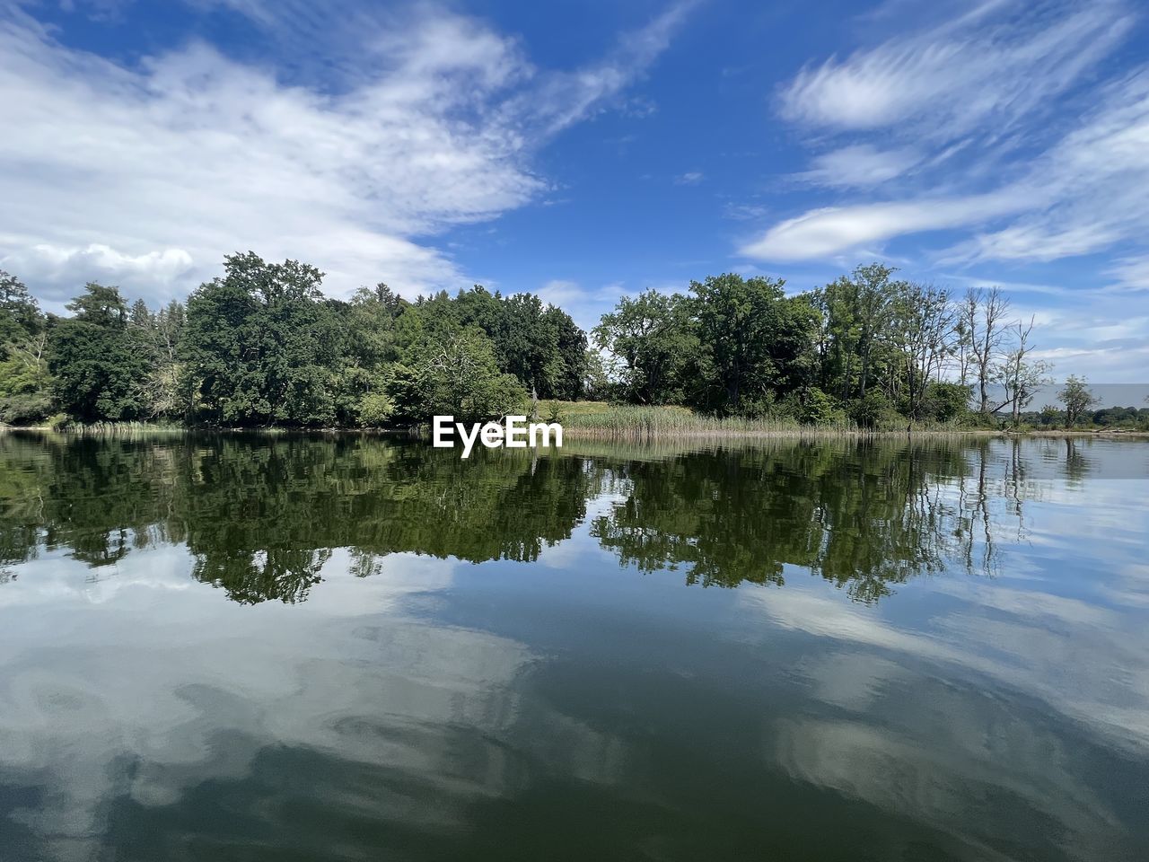 reflection, water, tree, nature, sky, lake, plant, beauty in nature, tranquility, scenics - nature, cloud, body of water, tranquil scene, environment, no people, reservoir, landscape, blue, outdoors, non-urban scene, travel destinations, forest, reflection lake, day, idyllic, travel, land, tourism, green, summer