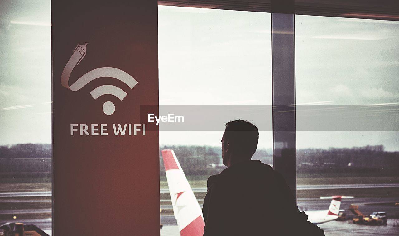 Man looking through airport window