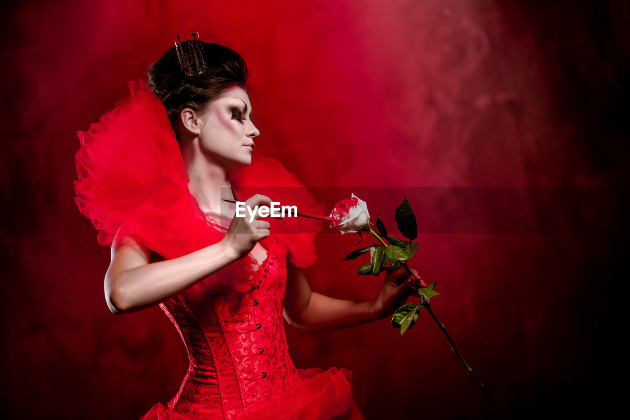 Young woman holding rose