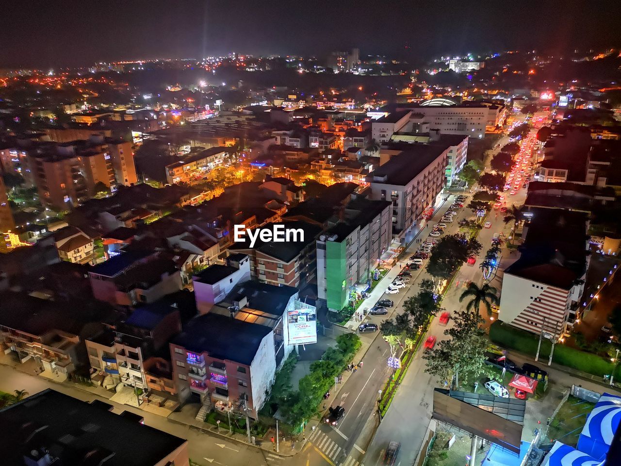High angle view of illuminated street amidst buildings in city