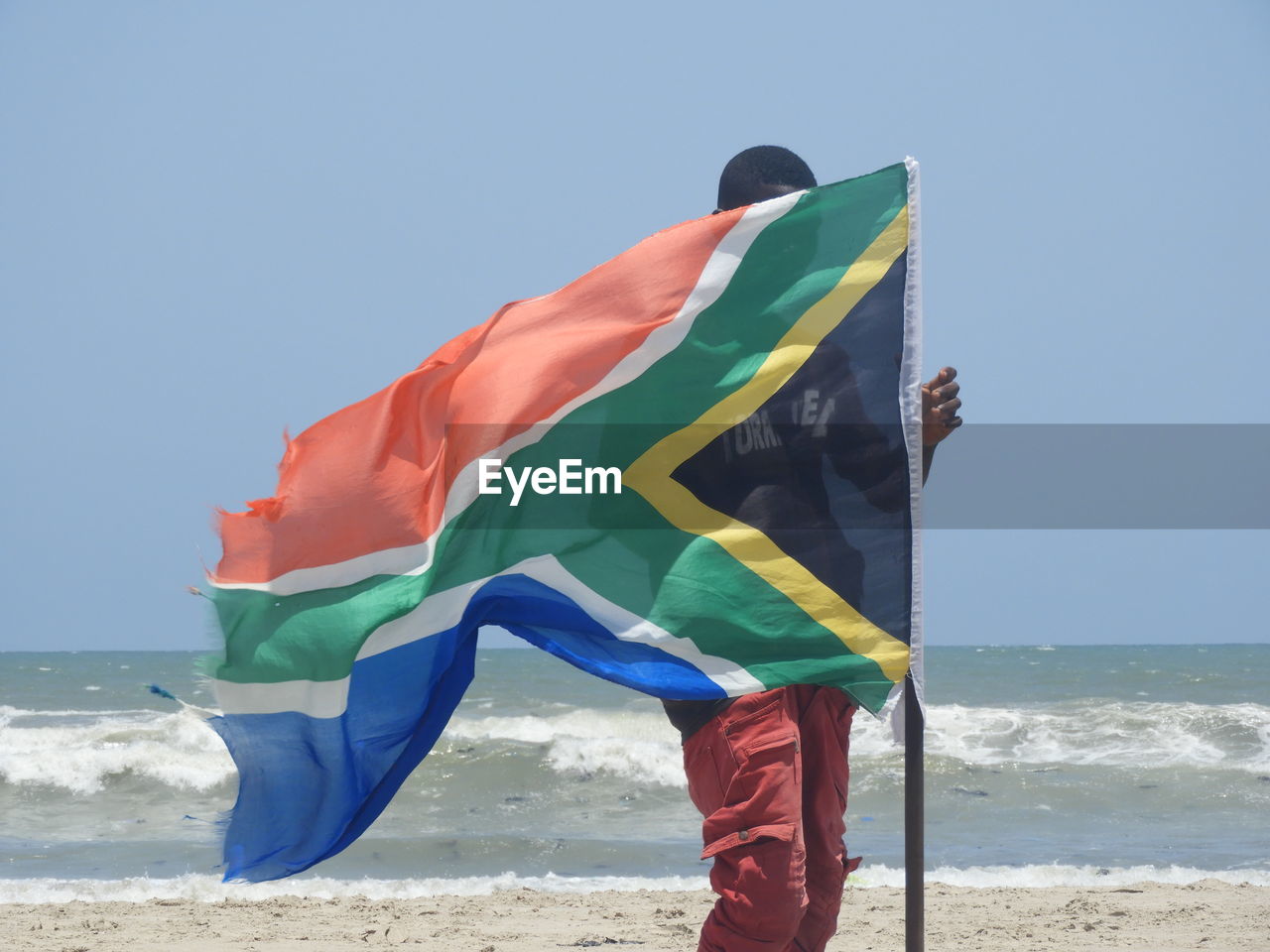 MAN FLAG ON BEACH