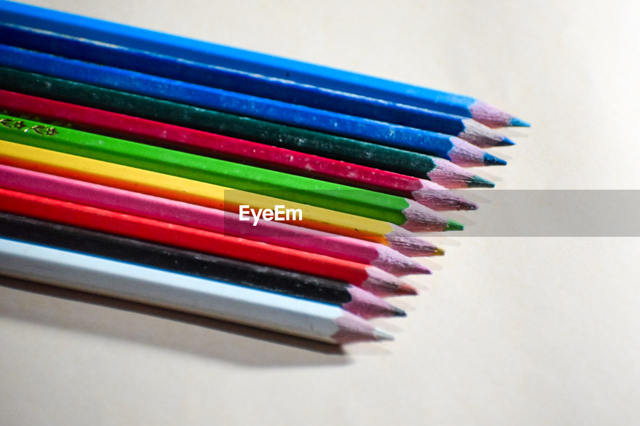 multi colored, pencil, colored pencil, variation, writing instrument, in a row, large group of objects, no people, indoors, close-up, still life, order, craft, creativity, arrangement, high angle view, education, wood, white background, office supplies, side by side, studio shot