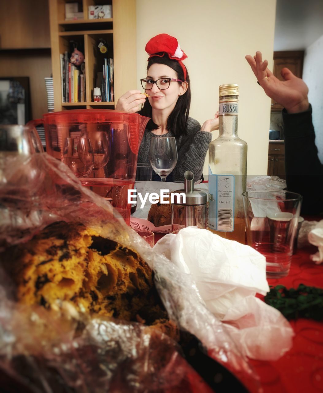 Portrait of smiling mid adult woman having food at home