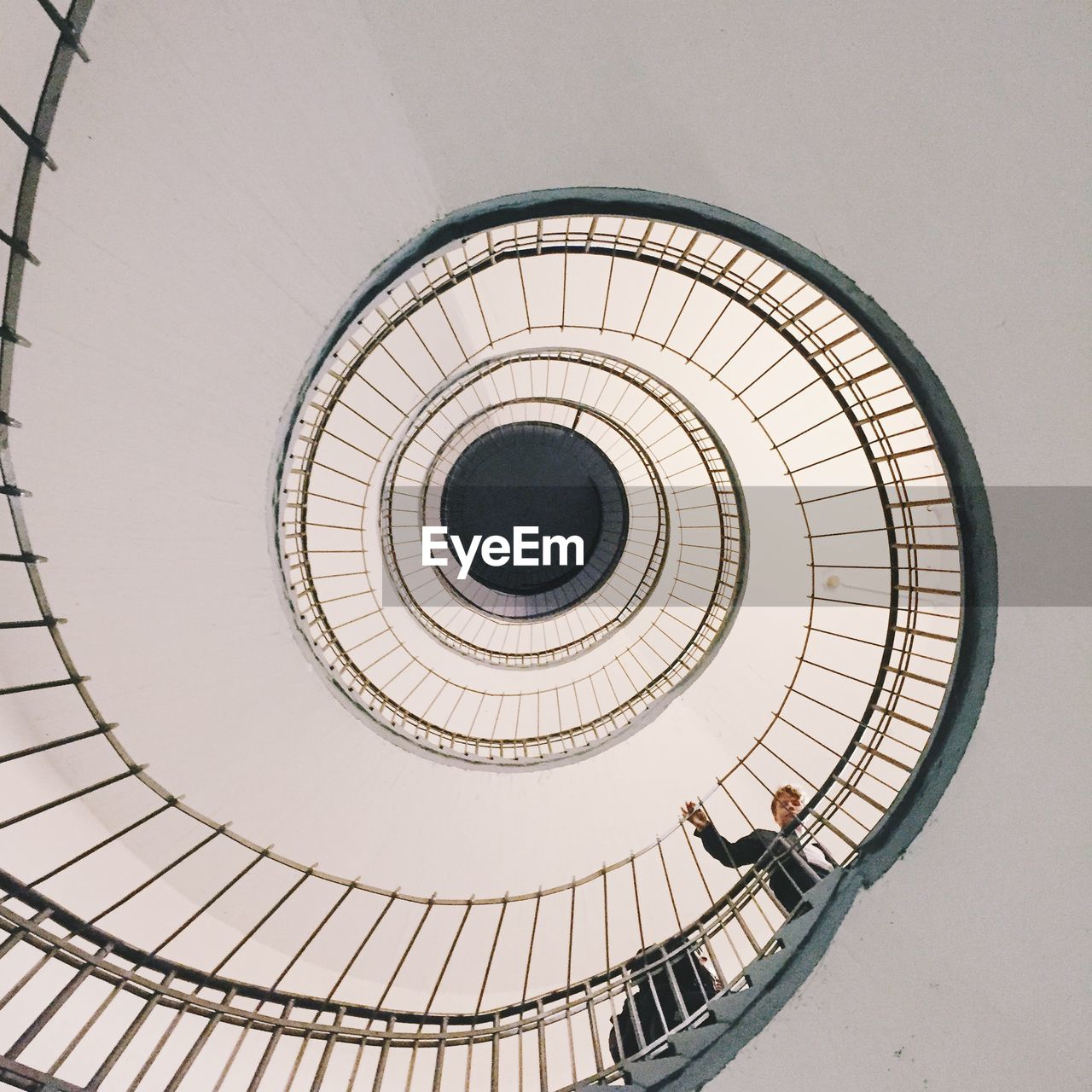 Directly below shot of man walking on spiral staircase at uebel and gefahrlich