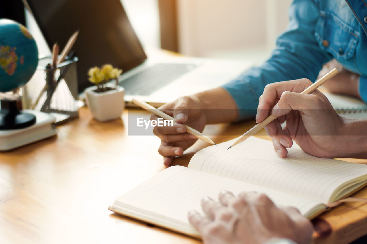 Close-up of business colleagues working in office