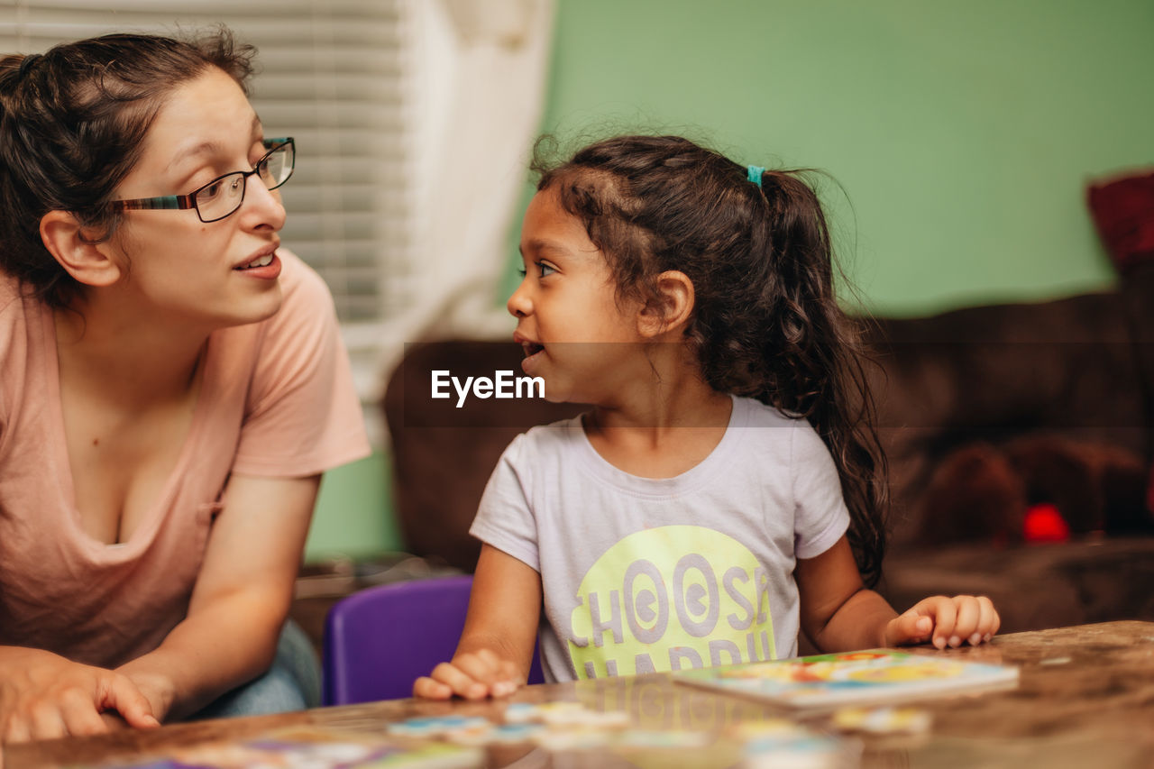 Mother assisting daughter in studies at home