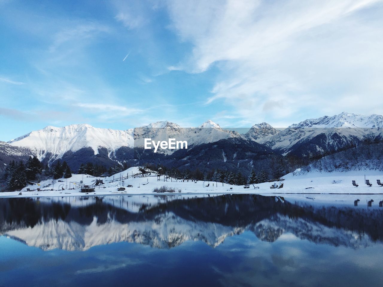 Scenic view of snowcapped mountains against cloudy sky