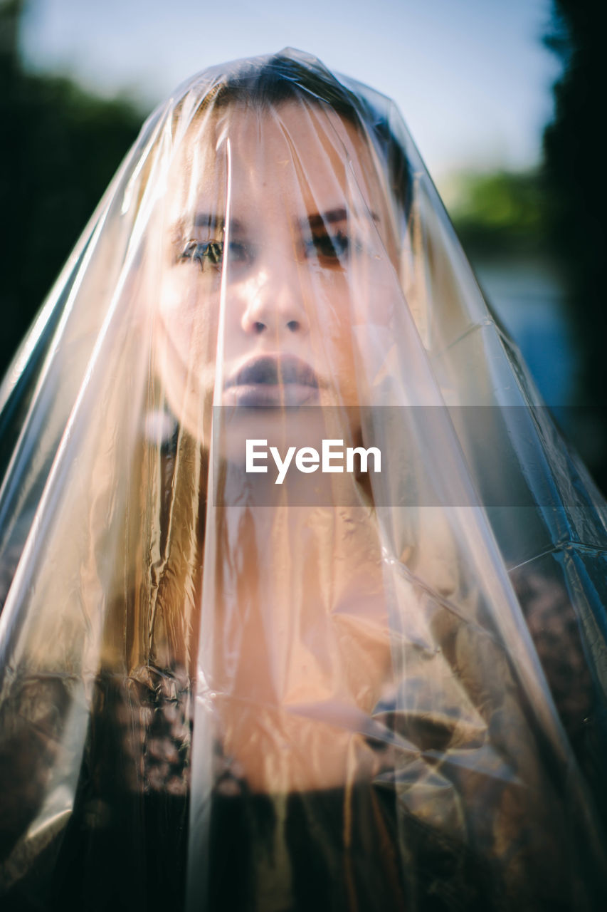 Portrait of young woman covered in plastic