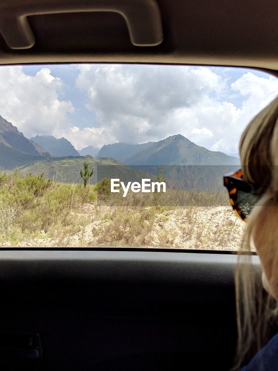 PORTRAIT OF MAN SEEN THROUGH CAR WINDSHIELD