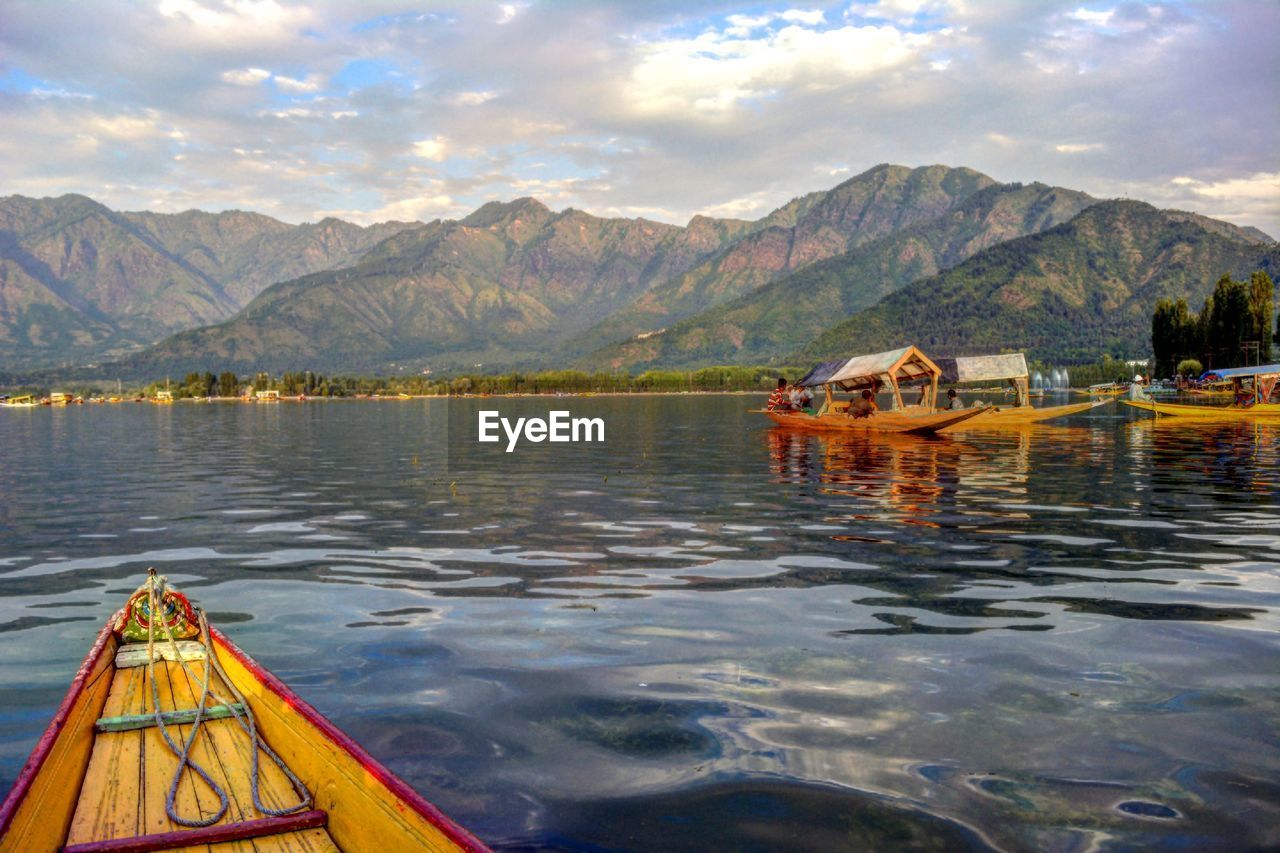 BOAT IN LAKE AGAINST MOUNTAINS