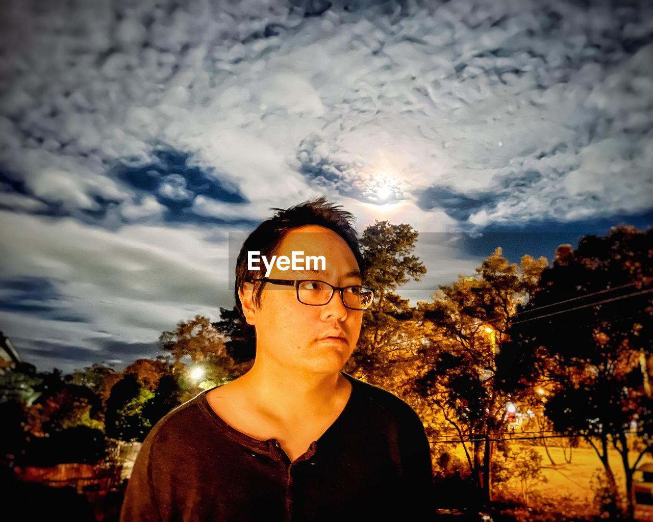 PORTRAIT OF YOUNG MAN AGAINST SKY DURING SUNRISE