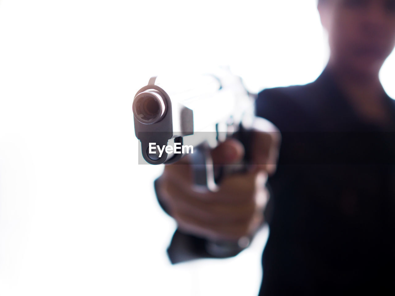 MIDSECTION OF MAN HOLDING CAMERA STANDING IN SIGN