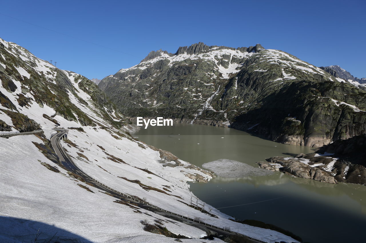 Scenic view of snowcapped mountains against clear sky