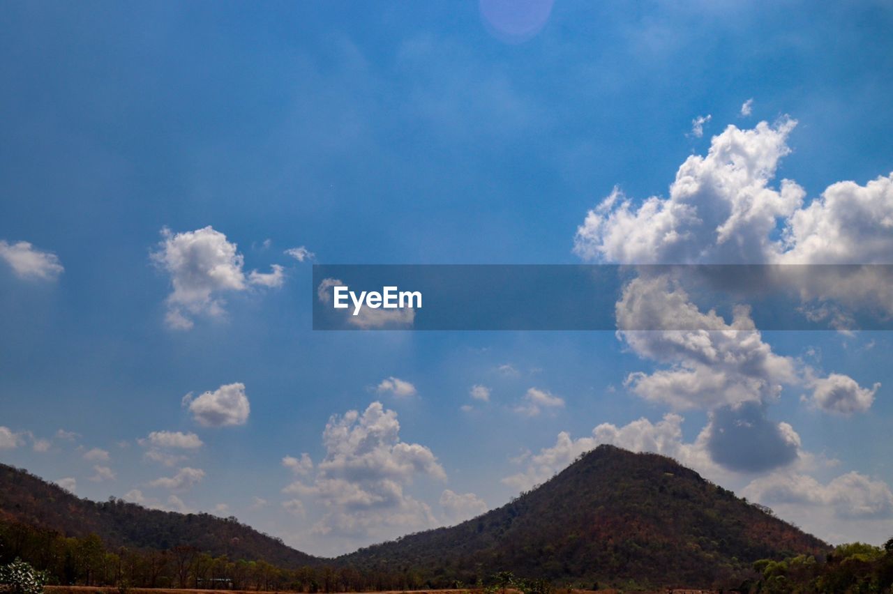 Low angle view of mountain against cloudy sky