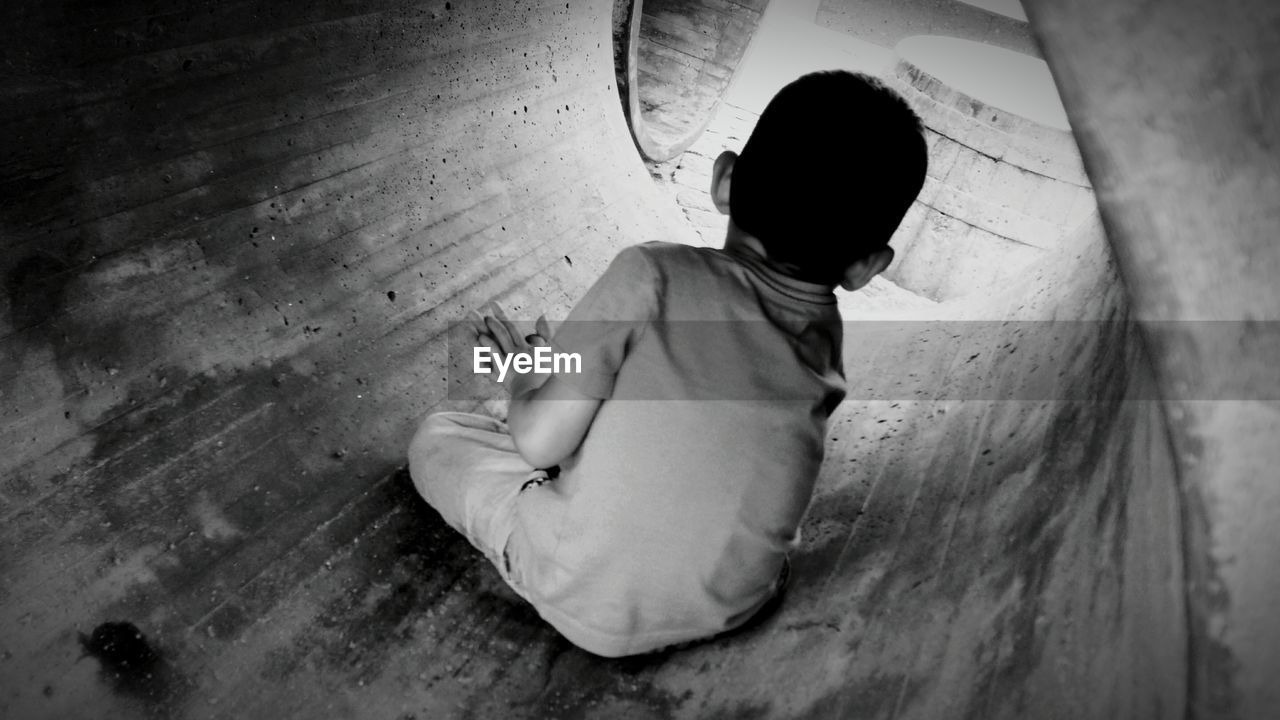 Rear view of boy in pipe