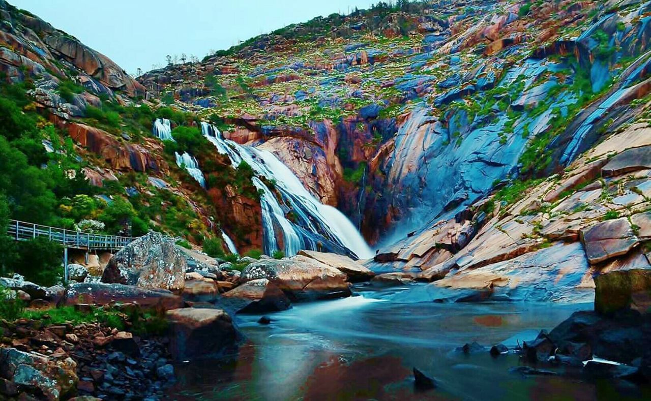 SCENIC VIEW OF ROCK FORMATIONS IN SEA