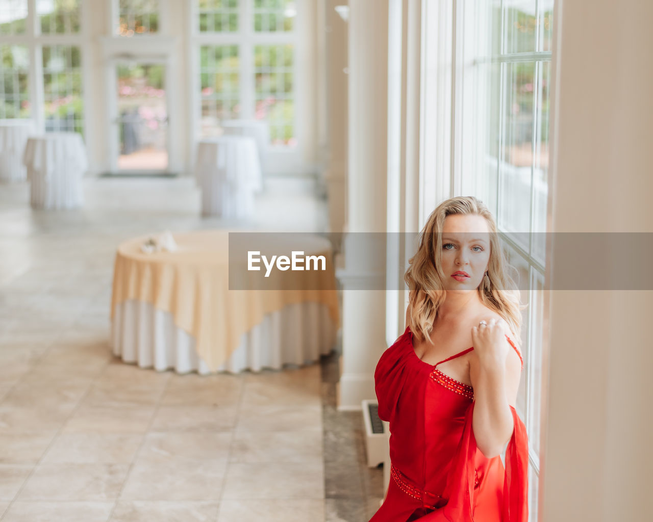 Portrait of beautiful young woman standing at home