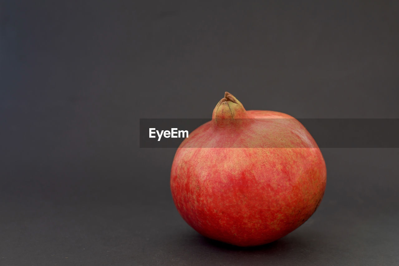 Close-up of pomegranate against black background