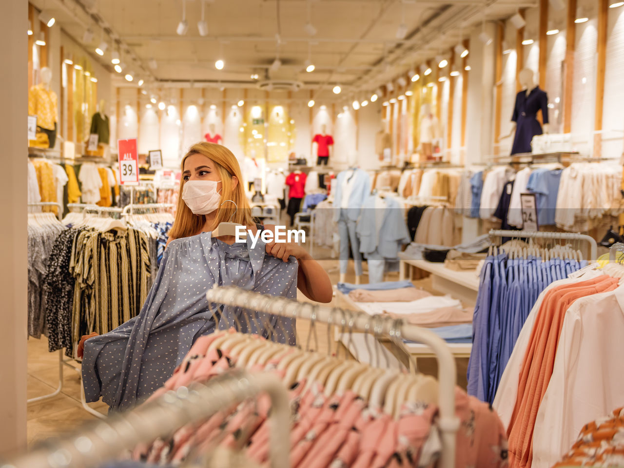 MIDSECTION OF WOMAN HOLDING STORE