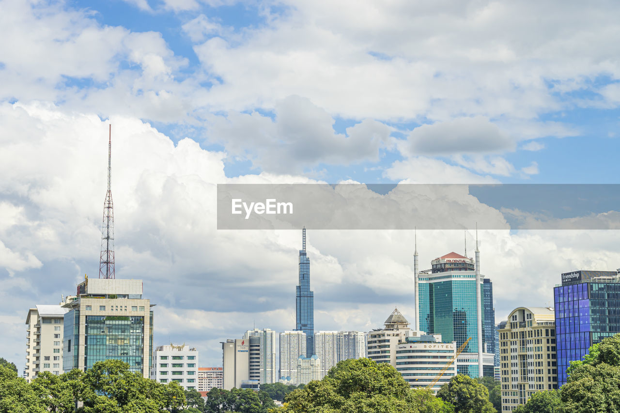 MODERN BUILDINGS AGAINST CLOUDY SKY